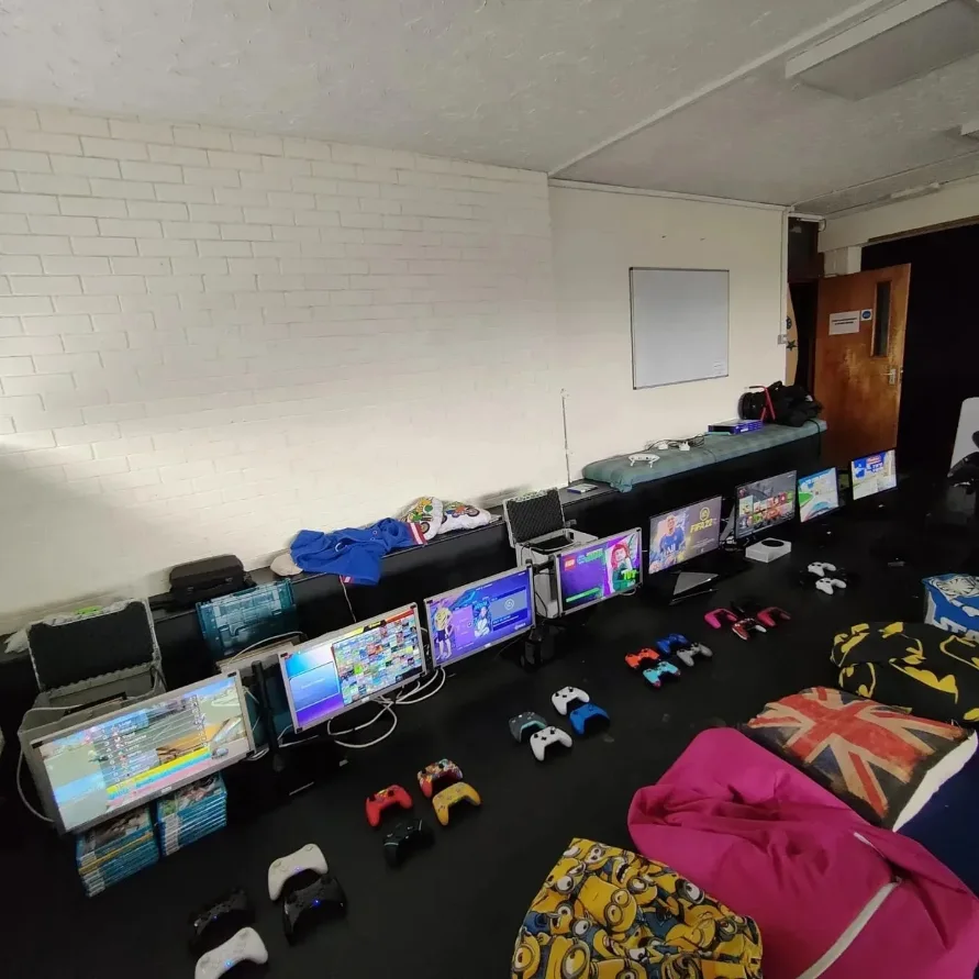 Console screens and controllers prepared for a gaming party
