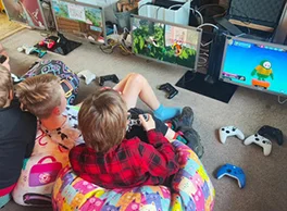 Kids playing multiplayer video gaming party